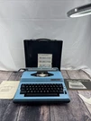 Vintage Blue Omega 300 Portable Electric Typewriter & Case And Manuals. Fixed Price $48.75.